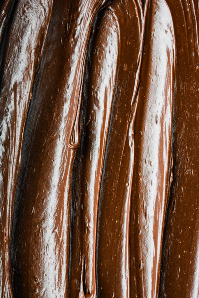 A smooth chocolate frosting spread on a cake.
