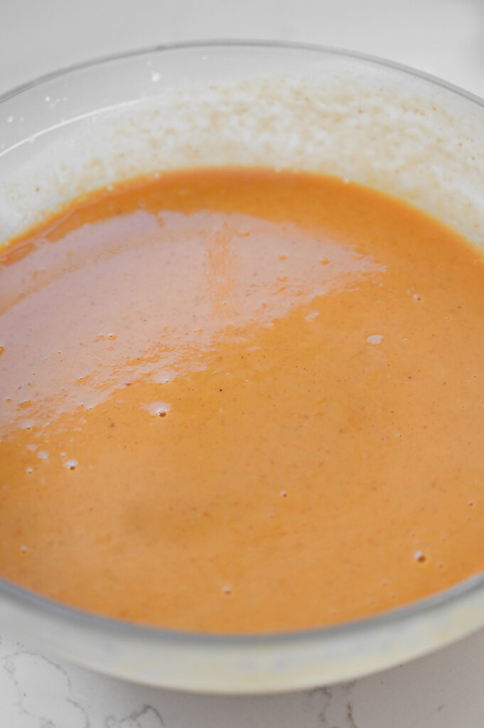 Pumpkin filling in a large glass bowl.