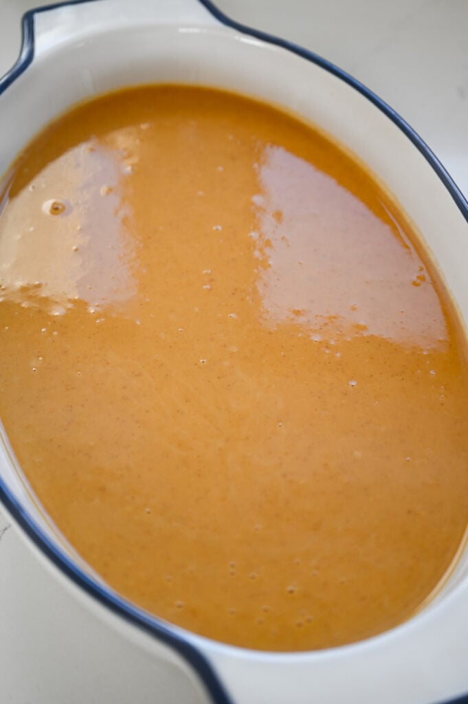 Pumpkin pie filling in a ceramic dish.