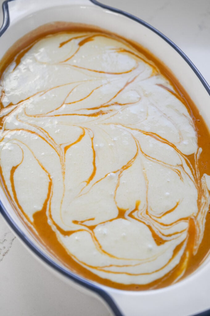 Cream cheese swirled in a pumpkin dessert.