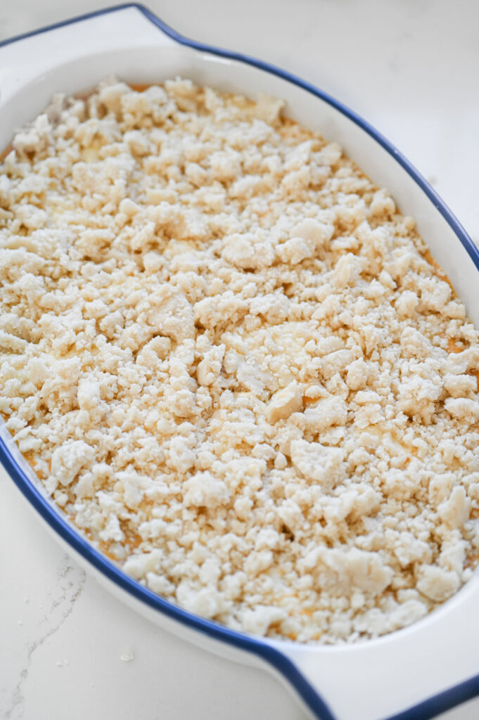 A ceramic dish with pumpkin filling and topped with a crumble.