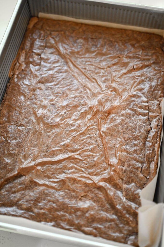 A 9x13 pan of brownies baked with a shiny top.