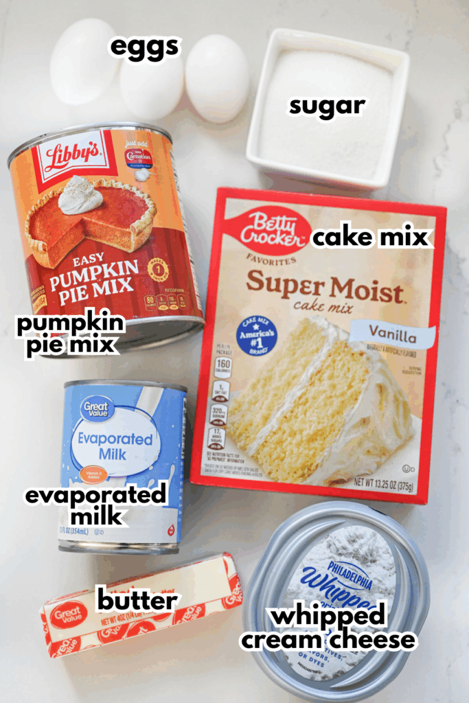 The ingredients needed to make a pumpkin dessert labeled on a white surface.