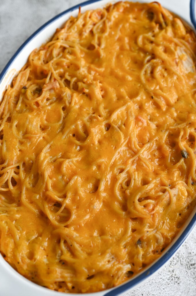 A baked casserole with melted cheddar cheese on top.