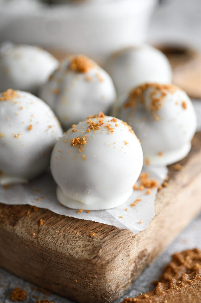 Biscoff truffles on a wooden board.