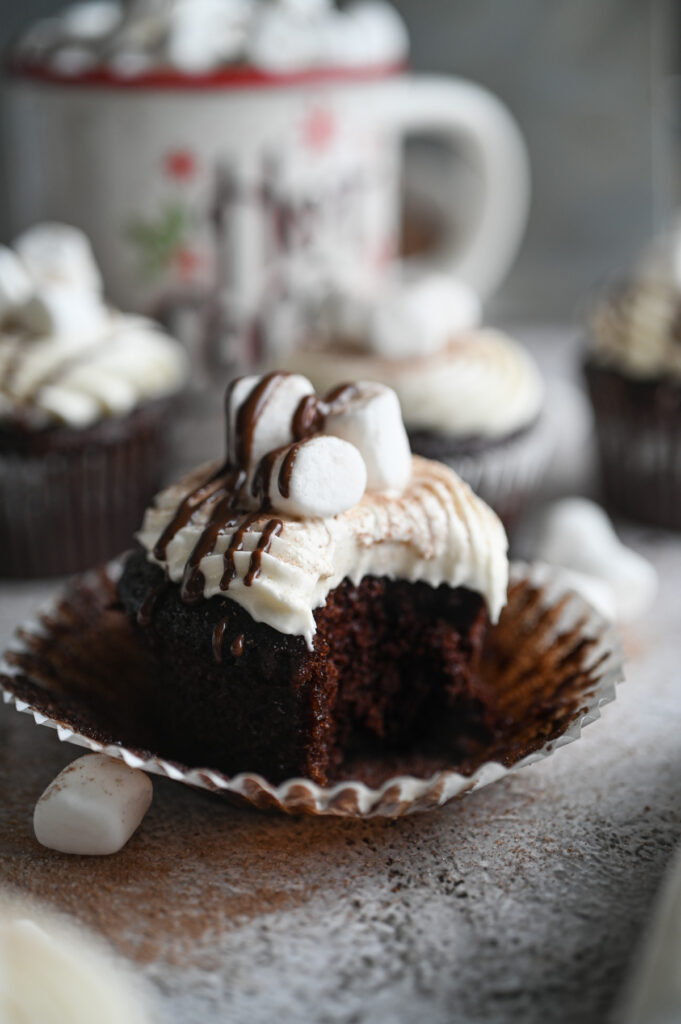 A hot chocolate cupcake with a bite out of it.