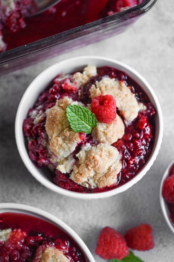 Overhead view of a bowl of raspberry cobbler.