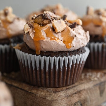 Better than anything cupcake on a wooden board.