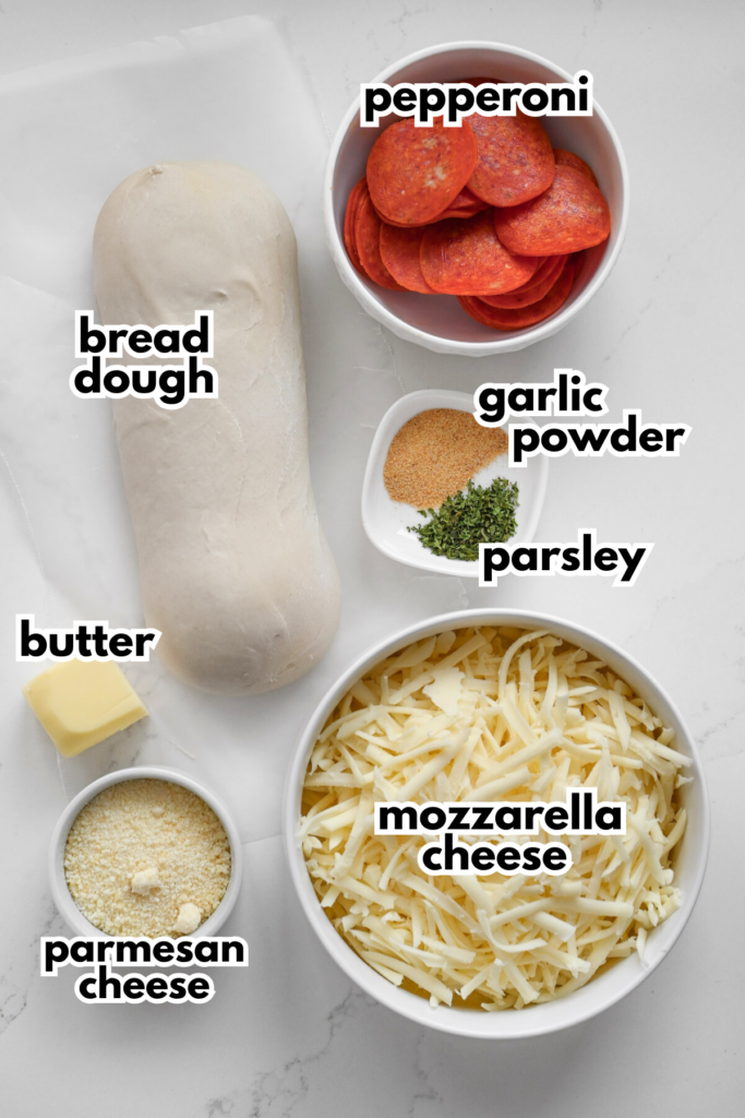 The ingredients needed to make pepperoni rolls on a white background with labels.