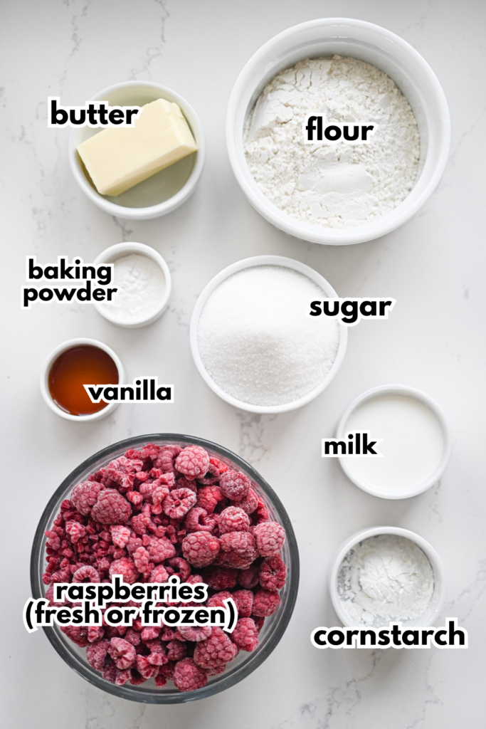 The ingredients needed to make a raspberry cobbler on a white background.