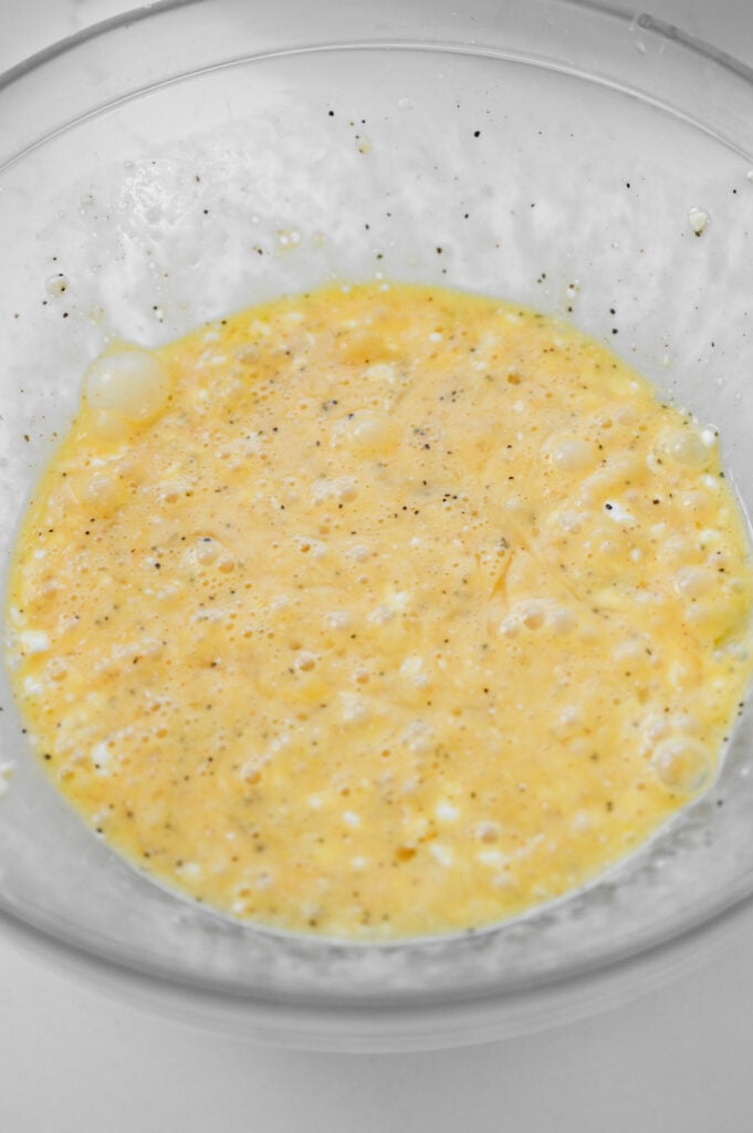 A clear glass bowl with uncooked eggs.