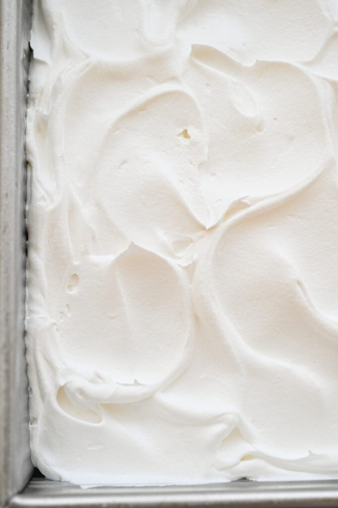 Whipped topping spread over a cake.