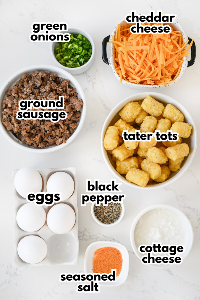 Several ingredients laid out on a white background with labels; everything needed to make breakfast tater tot casserole.