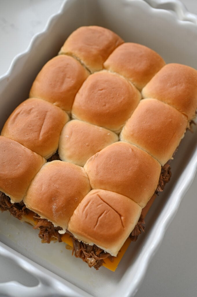 Pulled pork sliders in a dish.