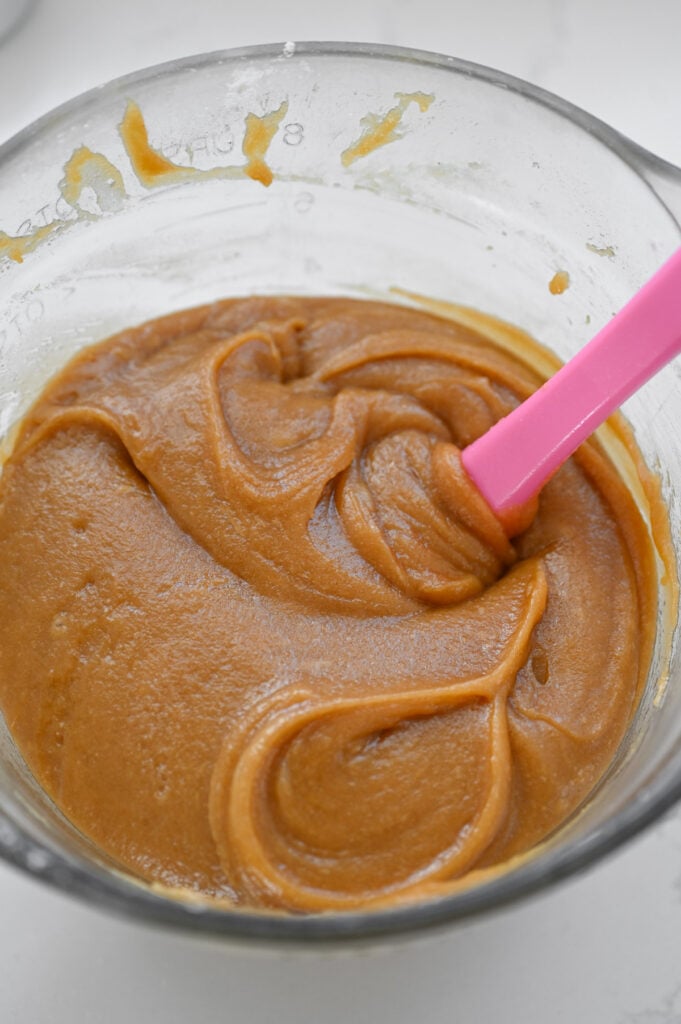 A caramel-colored cake batter in a mixing bowl.