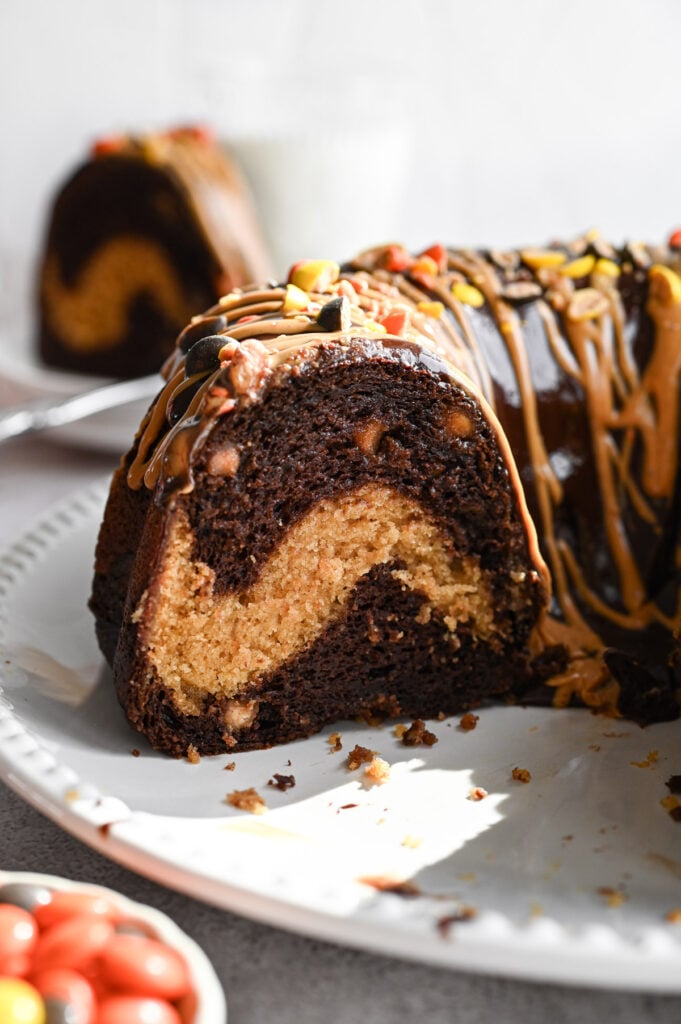 A bundt cake with a slice out of it to show the peanut butter swirl in the center.
