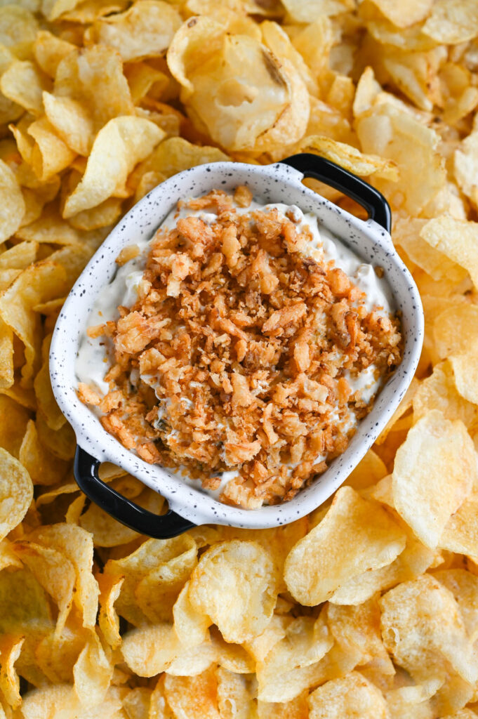 Overhead view of a bowl with Fried Pickle Dip and chips around it.