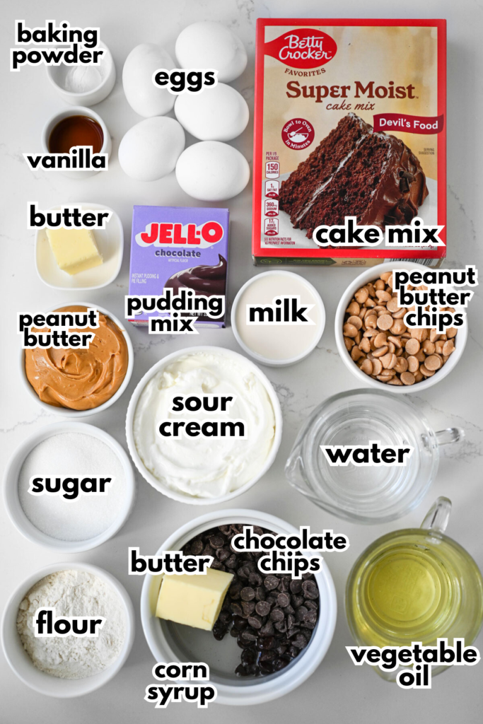 The ingredients needed to make a chocolate peanut butter cake on a white quartz background.