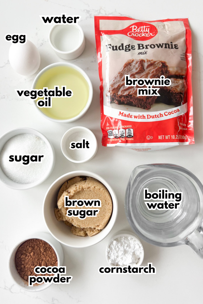 The ingredients needed to make Brownie Cobbler on a white quarts countertop.