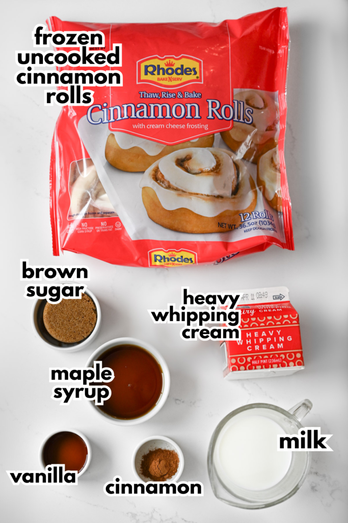 The ingredients needed to make a cinnamon roll casserole including frozen cinnamon rolls, brown sugar, heavy cream, milk, vanilla, cinnamon and maple syrup.