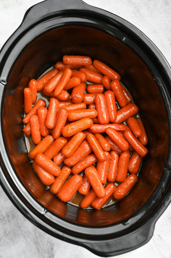 Overhead view of glossy baby carrots.
