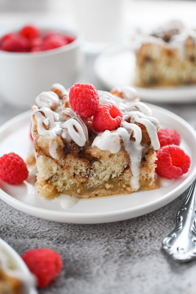 A piece of cinnamon roll casserole on a white plate.