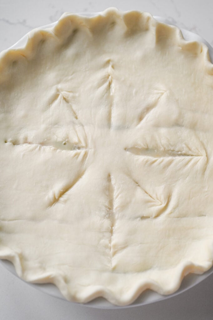A puff pastry-topped pot pie with vents sliced into the top.