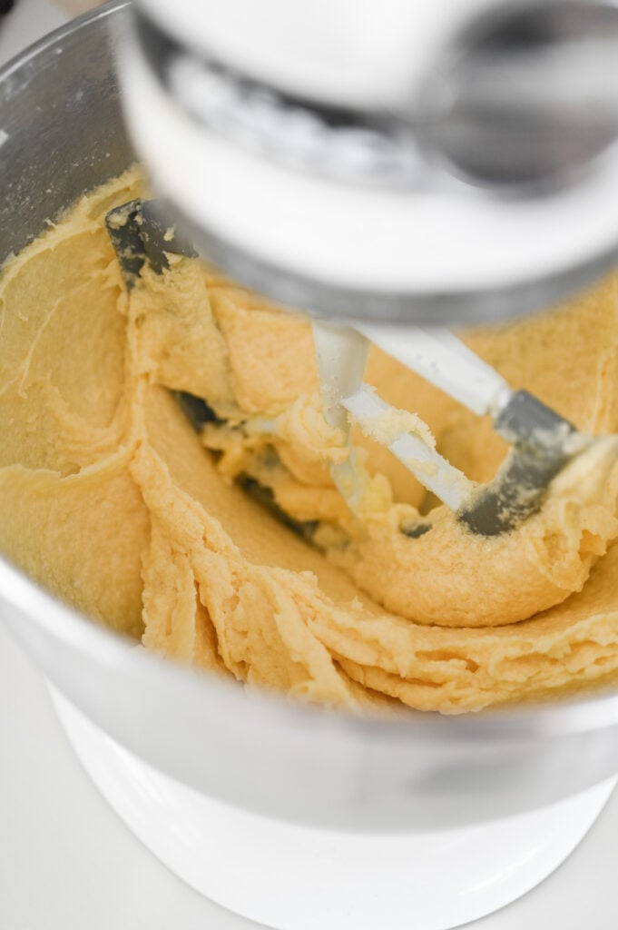 A cake batter being stirred together in a stand mixer.