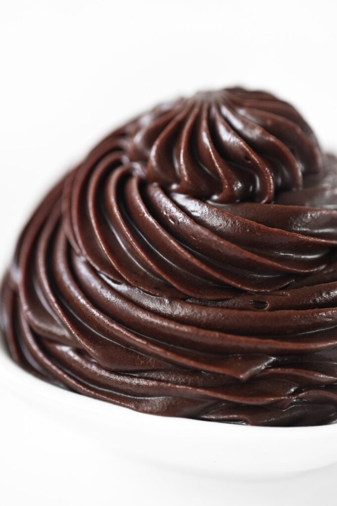 A close-up of piped chocolate frosting.