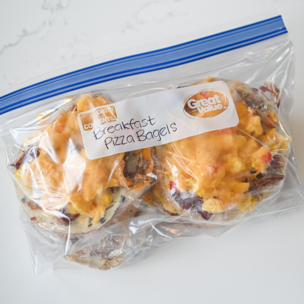 A freezer baggie with breakfast pizza bagels in it; labeled "breakfast pizza bagels."