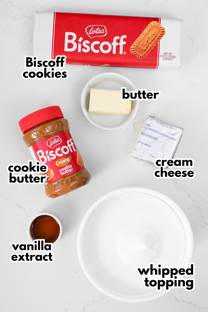 The ingredients needed to make a no bake Biscoff Pie on a white background - Biscoff cookies, butter, cream cheese, cookie butter, vanilla and whipped cream.