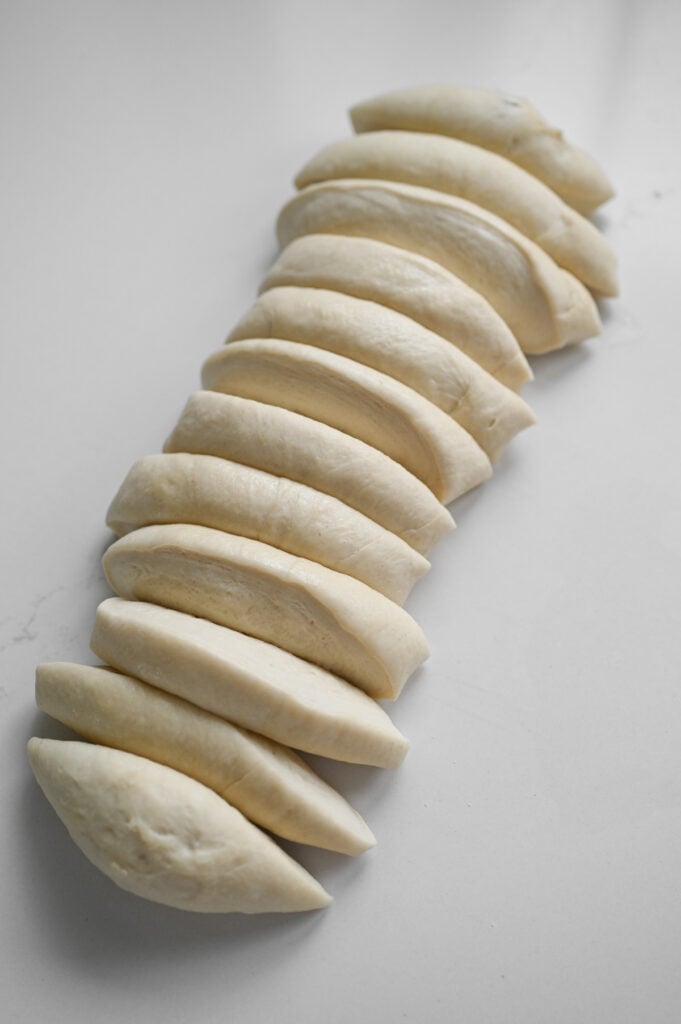 A pound of bread dough cut into 12 even pieces.