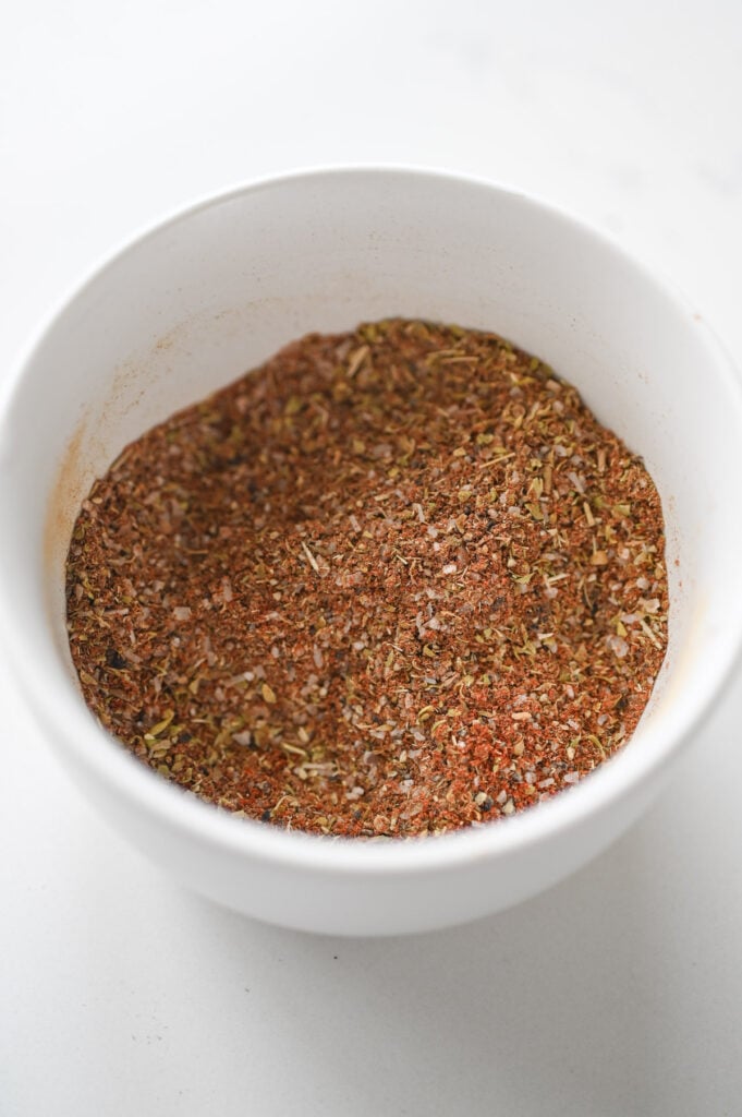 A pork rub in a small white dish.