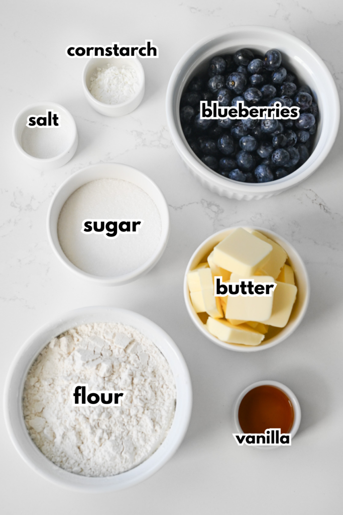 The ingredients needed to make blueberry crumble bars on a white background.