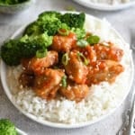 A plate with sticky pork on rice.