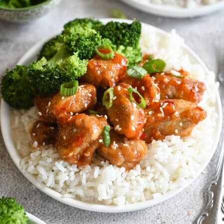 A plate with sticky pork on rice.
